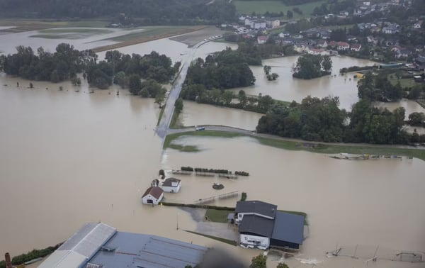 Houses, farm land and streets partially under water